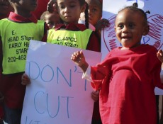 IMAGE: Children stand in front of the Capitol on Oct. 2, 2013 during a rally urging the government to halt spending cuts to Head Start. (Photo: Taylor Hartz, BU News Service)