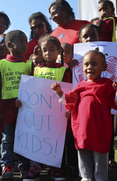 IMAGE: Children stand in front of the Capitol on Oct. 2, 2013 during a rally urging the government to halt spending cuts to Head Start. (Photo: Taylor Hartz, BU News Service)