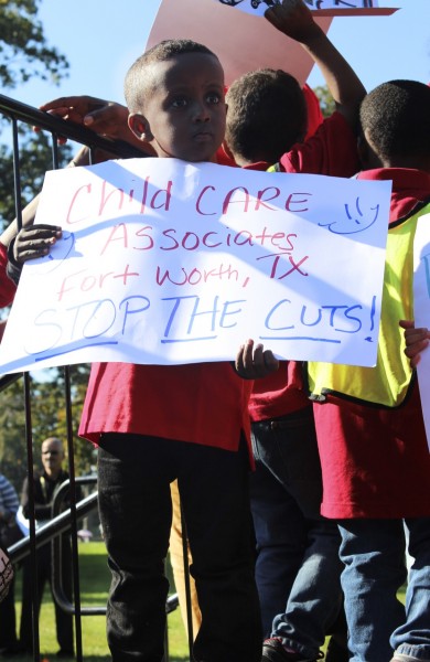 IMAGE: Children stand in front of the Capitol on Oct. 2, 2013 during a rally urging the government to halt spending cuts to Head Start. (Photo: Taylor Hartz, BU News Service)