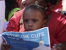 IMAGE: Children stand in front of the Capitol on Oct. 2, 2013 during a rally urging the government to halt spending cuts to Head Start. (Photo: Taylor Hartz, BU News Service)